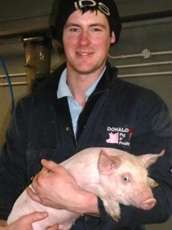 Young Pig Farmer of the Year, Matt Donald, with one of his piglets
